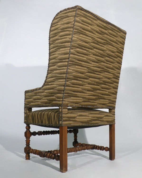 Spanish style wingback chair with highly patinaed nail head trim. This originated from the personal estate of Robert Floyd owner of the world famous Fitz and Floyd China Company. Very Handsome detailing.