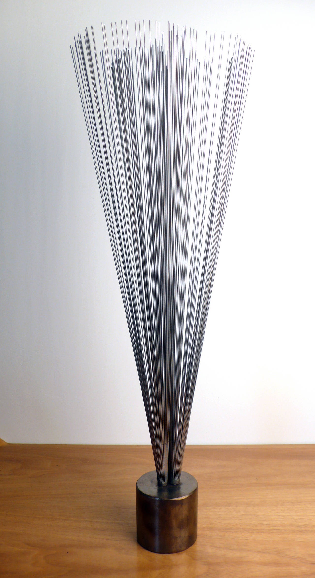 Early Harry Bertoia Spray in Bronze Base. Three conical branches of stainless wires mounted to a bronze cylindrical base.
Sold with a title of authentication from Bertoia Studio.