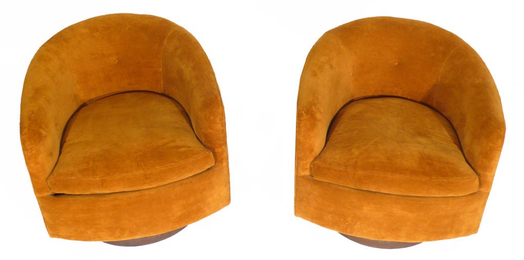 Authentic pair of Milo Baughman designed barrel back lounge chairs for Thayer Coggin. Both chairs rock and swivel and are extremely comfortable. Original orange velvet upholstery and walnut bases. Retains original label. Price is for the pair.