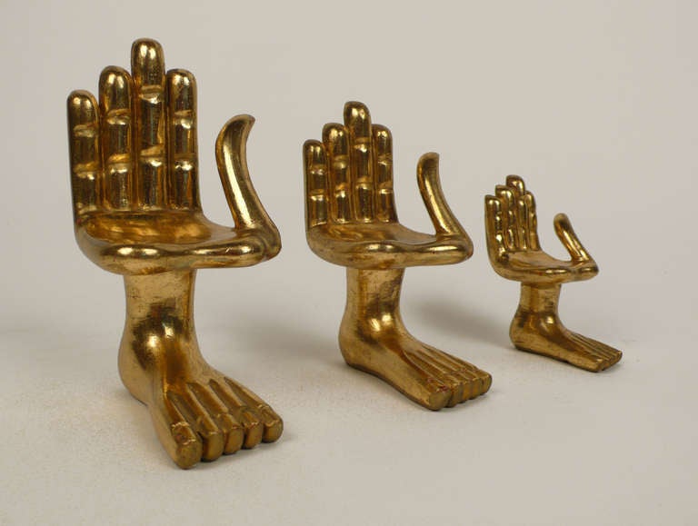 Collection of three different size Pedro Friedeberg miniature hand/foot chair sculptures. All three are signed on the bottom. 24 Karat gold leaf over mahogany. These are early originals. Priced per chair. Sold only as a