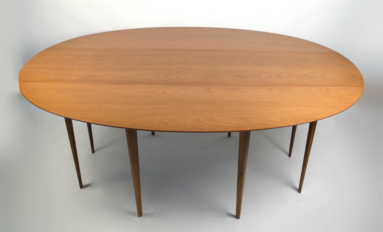 Bleached walnut drop-leaf gateleg table with faceted legs attributed to Edward Wormley for Dunbar. When leaves are down will also double as a console table. Perfect for small spaces or for occasions where extra space becomes necessary. Very