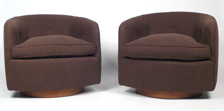 Pair of Milo Baughman designed tilt-back revolving barrel back club chairs for Thayer Coggin with walnut bases.