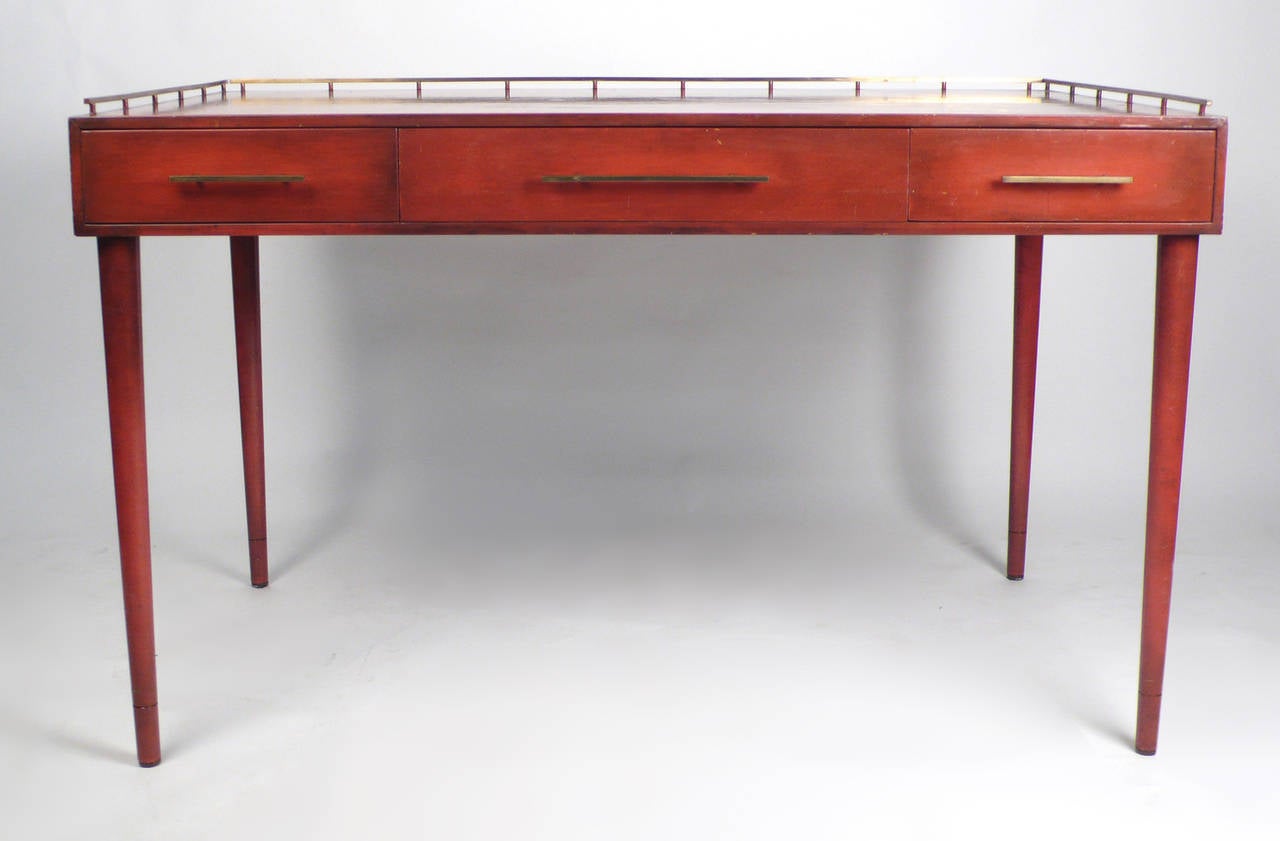 Unique three-drawer writing desk by Imperial Furniture Company with brass trim made in Grand Rapids Michigan 1960s. Needs new lacquer or finish.