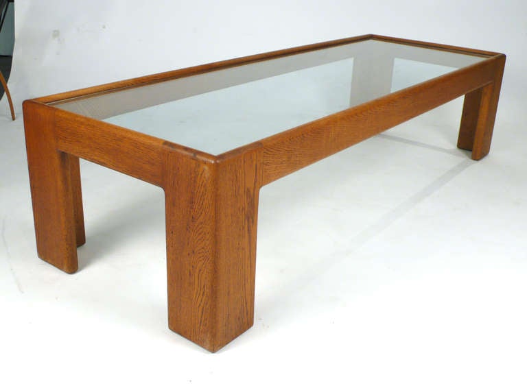 Solid oak coffee/cocktail table designed by Jim Eldon for Knoll. Has inset glass top.