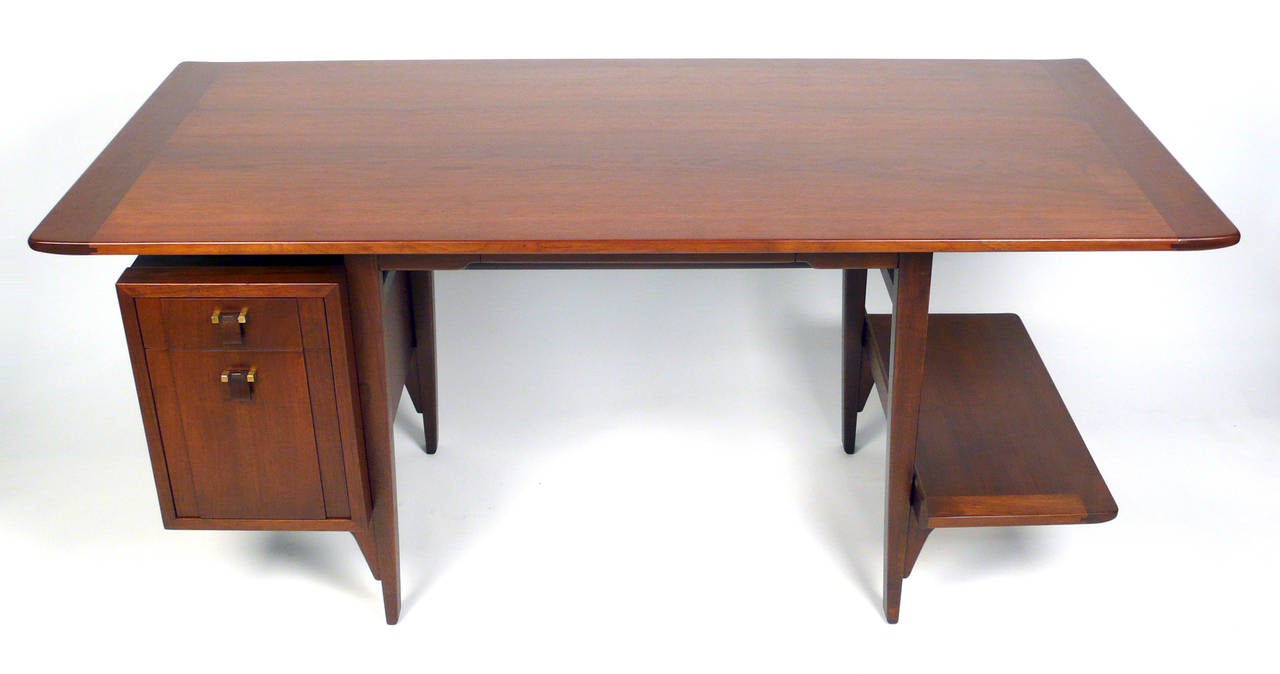 Masterfully designed writing desk by Edward Wormley for Dunbar. Single bank of drawers with pencil drawer and display shelf. Solid Mahogany. This is a rare and early design and is signed with applied gold rectangular manufacturer's label to drawer: