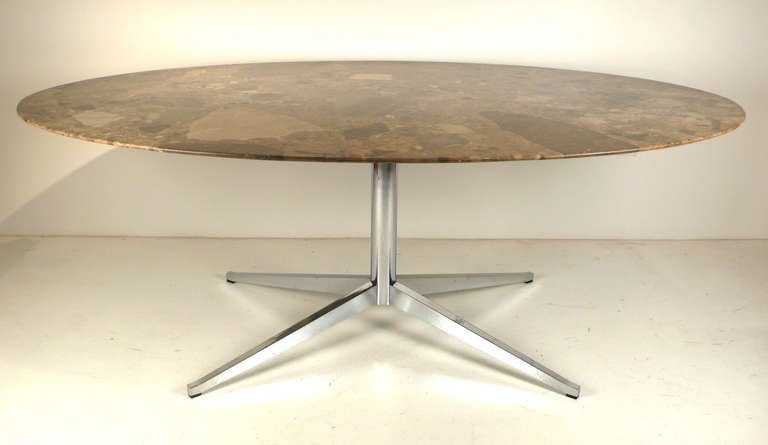 Gorgeous Florence Knoll designed oval emperador marble table/desk. Would serve well as a dining table too. There are lots of unique geodes visible throughout the surface with a sharp knife edge bevel. 

We have several of these tables available if