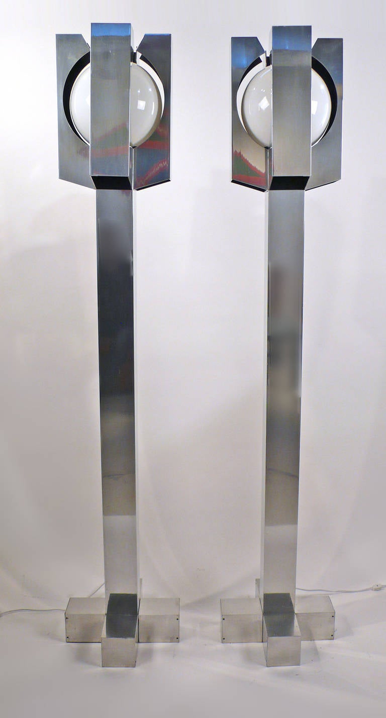 Pair of mirror polished aluminum and glass floor lamps. These lamps were reportedly custom-made for the SMU library in the late 1960s. The lamps were designed to be used as floor lamps but can also be mounted to the ceiling.