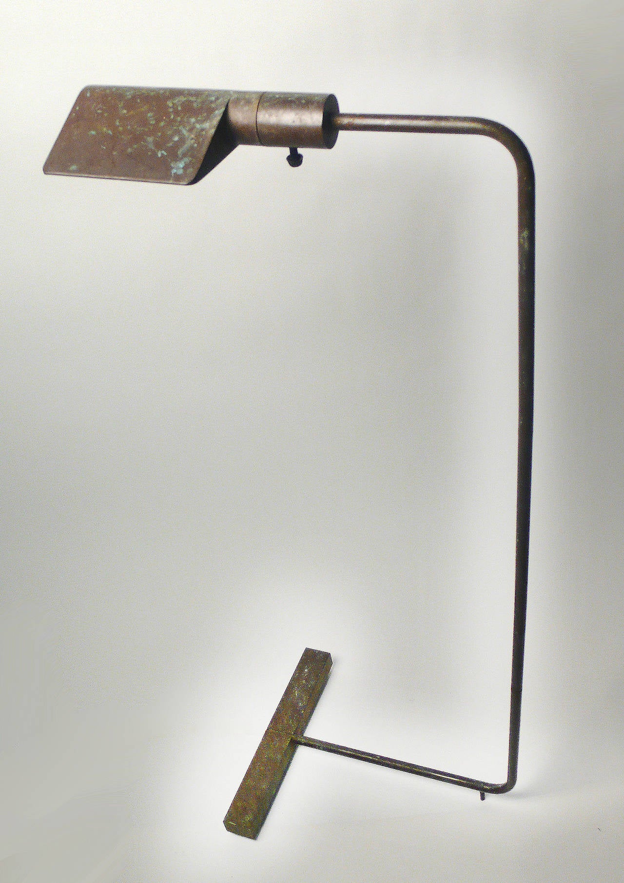 Bronze floor lamp with pivoting shade and pivoting arm. The solid bronze counterweighted base tucks neatly under your favorite chair or sofa to provide a beautifully balance Minimalist source of light for reading. Signed and numbered to underside of