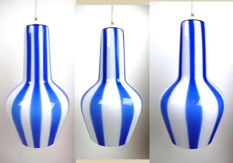 Set of three original vintage 1950s glass pendant lamps designed by Massimo Vignelli for Venini. All three lamps are free of any flaws and are identical in shape and size. Since the glass is hand made the stripe pattern is unique to each