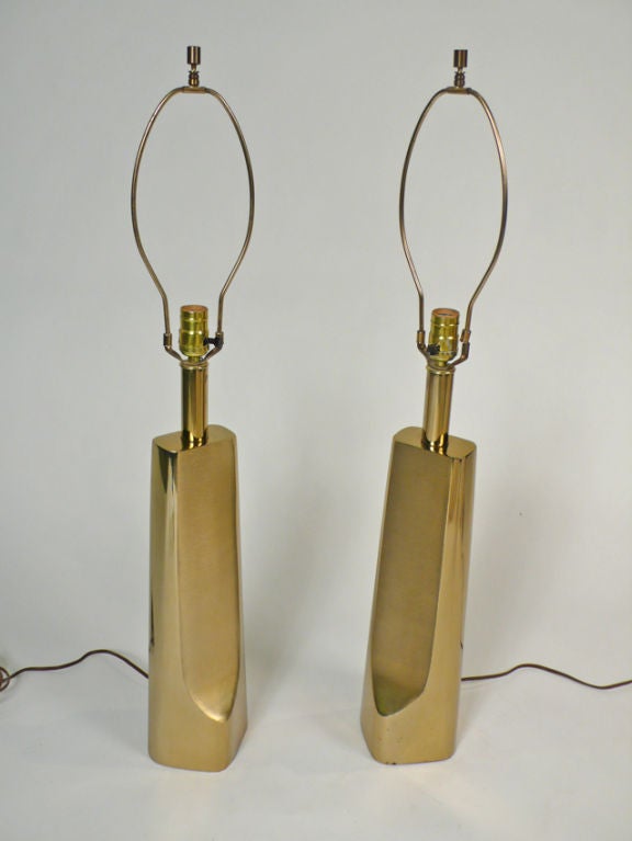 Pair of lamps by Laurel Lamp Co. Sculptural polished brass with brushed detailing and original shades.