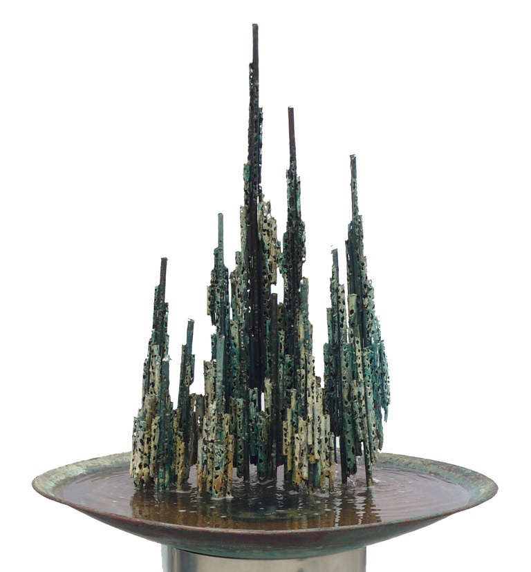 Brutalist fountain sculpture created in 1968 by Chicago Artist Thomas Hibben. Signed to edge of Copper Bowl. The motor conceals beneath the sculpture pumping the water out of the top of  the pipes. The flow is adjustable for each pipe and the sounds