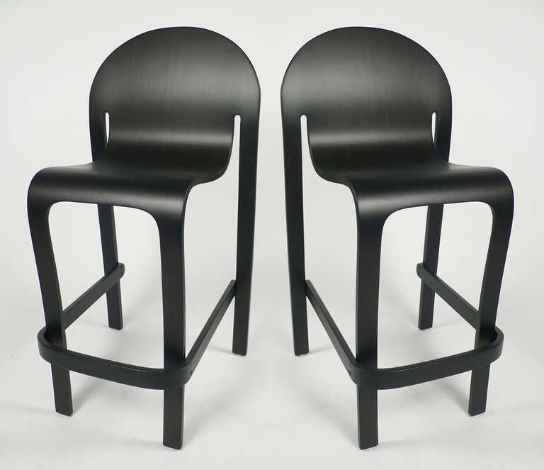 Two vintage Peter Danko designed barstools professionally restored in a matte black aniline dyed finish. The wood grain is still visible through the finish.

These barstools were designed as part of the Bodyform line of furniture by Peter Danko, a