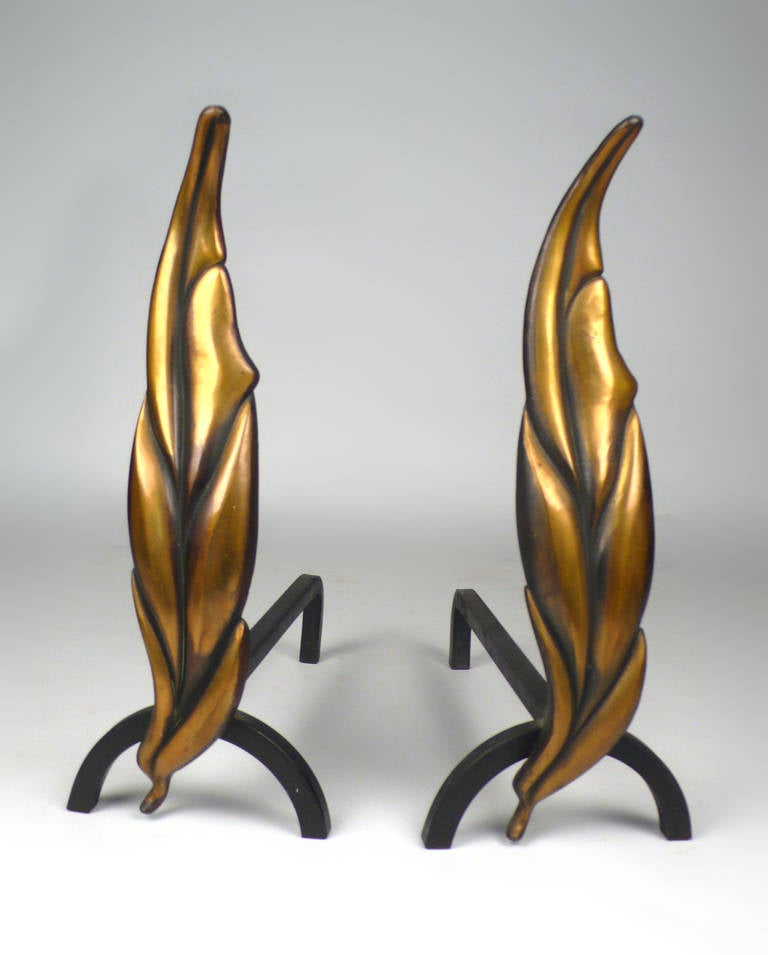 Artist signed, designed by Don Lipsey and Niel Peper in the late 40s/early 50s. Manufactured in NY. They were sold exclusively through Hammacher-Schlemmer catalogs. Solid brass, stylized andirons in the form of a leaf-shaped like a flame. Very