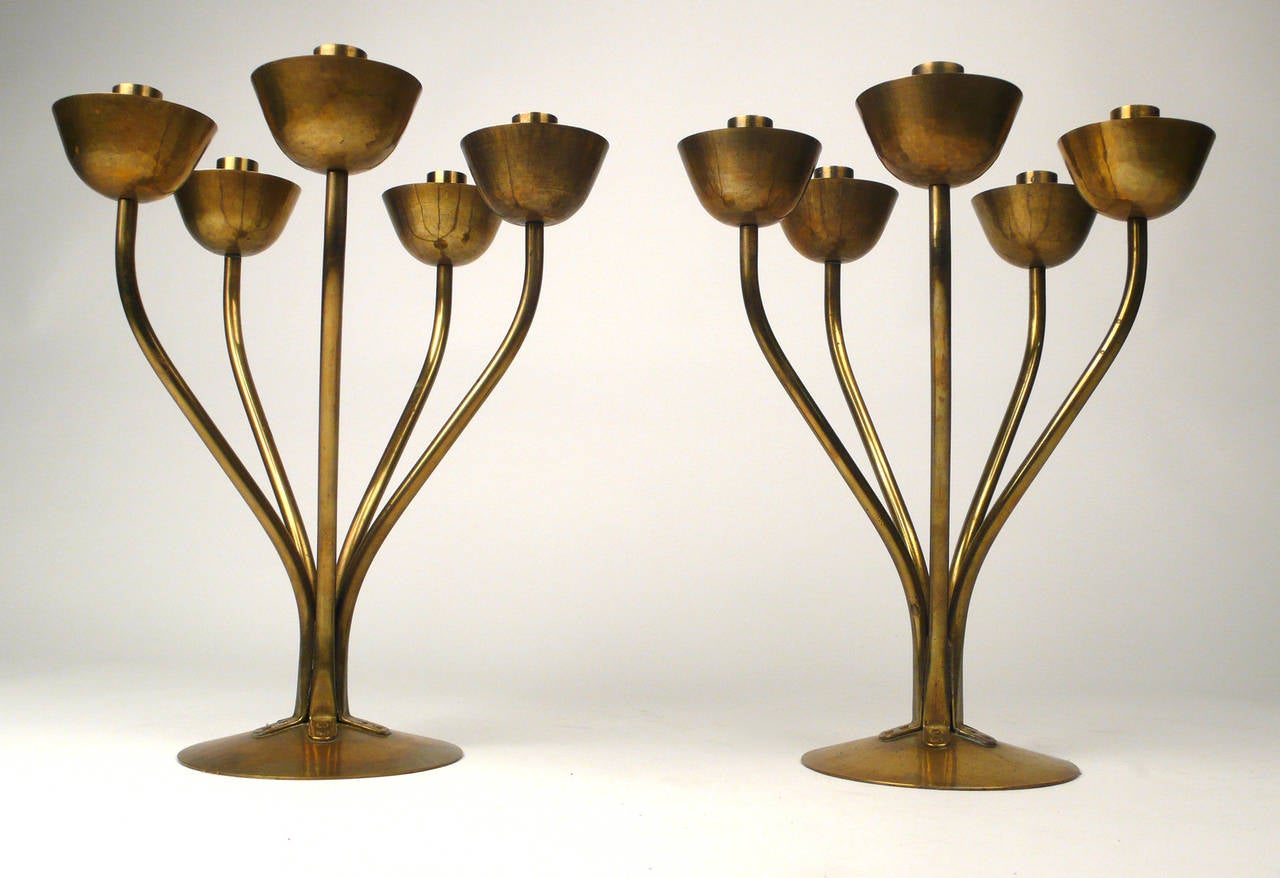 Exquisite pair of hand-hammered brass candelabrum by Bauhaus period manufacturer Hayno Focken. Both pieces are in exceptional condition and have a very warm patina.