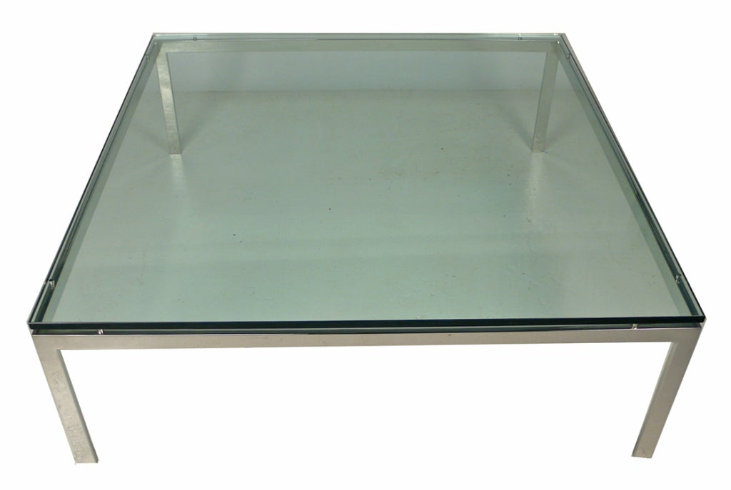 Beautiful and oversize Jacob Epstein glass top table by Cumberland crafted from solid flat bar mirror polished stainless steel with floating glass top.