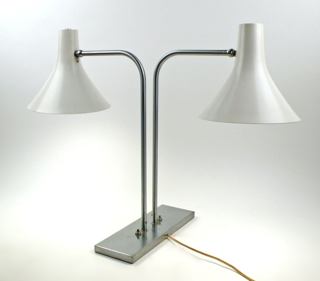 Iconic desk lamp with pivot and swivel cone shades designed by Gretta Von Nessen for Nessen Studios. Lamp is constructed with brushed nickel with lacquered shades.