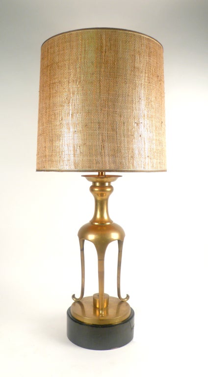 Patinated brass 1950's table lamp with original shade. Remarkably similar to the one in the living room of John Wayne's California mansion.

Shade is 19