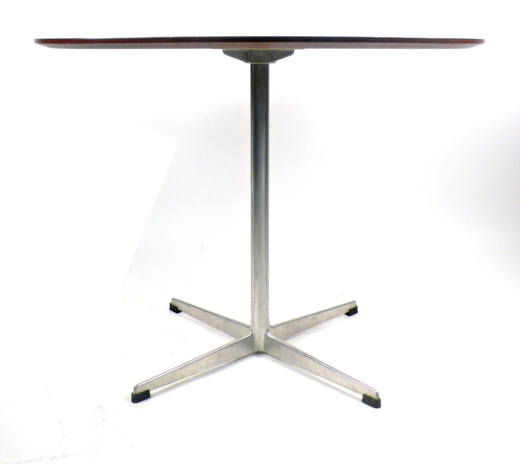 Designed by Arne Jacobsen and Produced by Fritz Hansen in Denmark this is table would serve well as a small cafe style breakfast table or an entry way or game table.