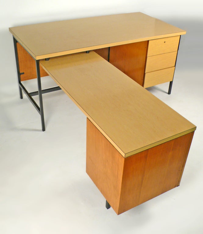 Florence Knoll Desk model #1544 EWR with natural woven cane KC-4 kneehole modesty panel. Top drawer retains the original pencil tray and functional locking device for all three drawers. The return consists of a veneered stationary pedestal with