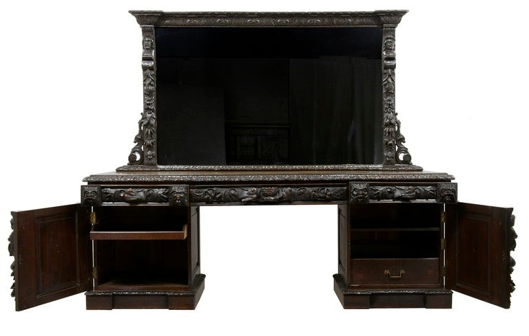 19th century carved oak mirrored sideboard dresser bar

A stunning sideboard dresser of monumental proportions.
Also With the original cellarette draw In the right hand pedestal behind the door ( used to cool wines and Champagne) 
 
In very