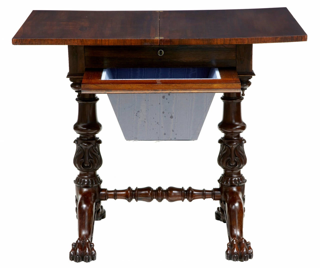 Beautiful rosewood work table, circa 1830. 

Stunning large carved base, with carved foliage stems. Single drawer now minus the partitions. Pull-out compartment below. Flip-top rotates and opens to form a larger surface.

Standing on lion paws