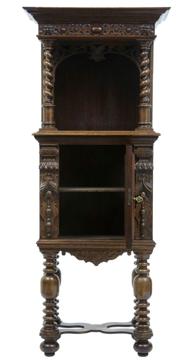 Fine quality Victorian oak hall cupboard, incorporating older carved elements. Main feature of this unusual piece is the carved Adam and Eve panel on the door. Comprising of two parts, the upper section contains a cupboard space which could