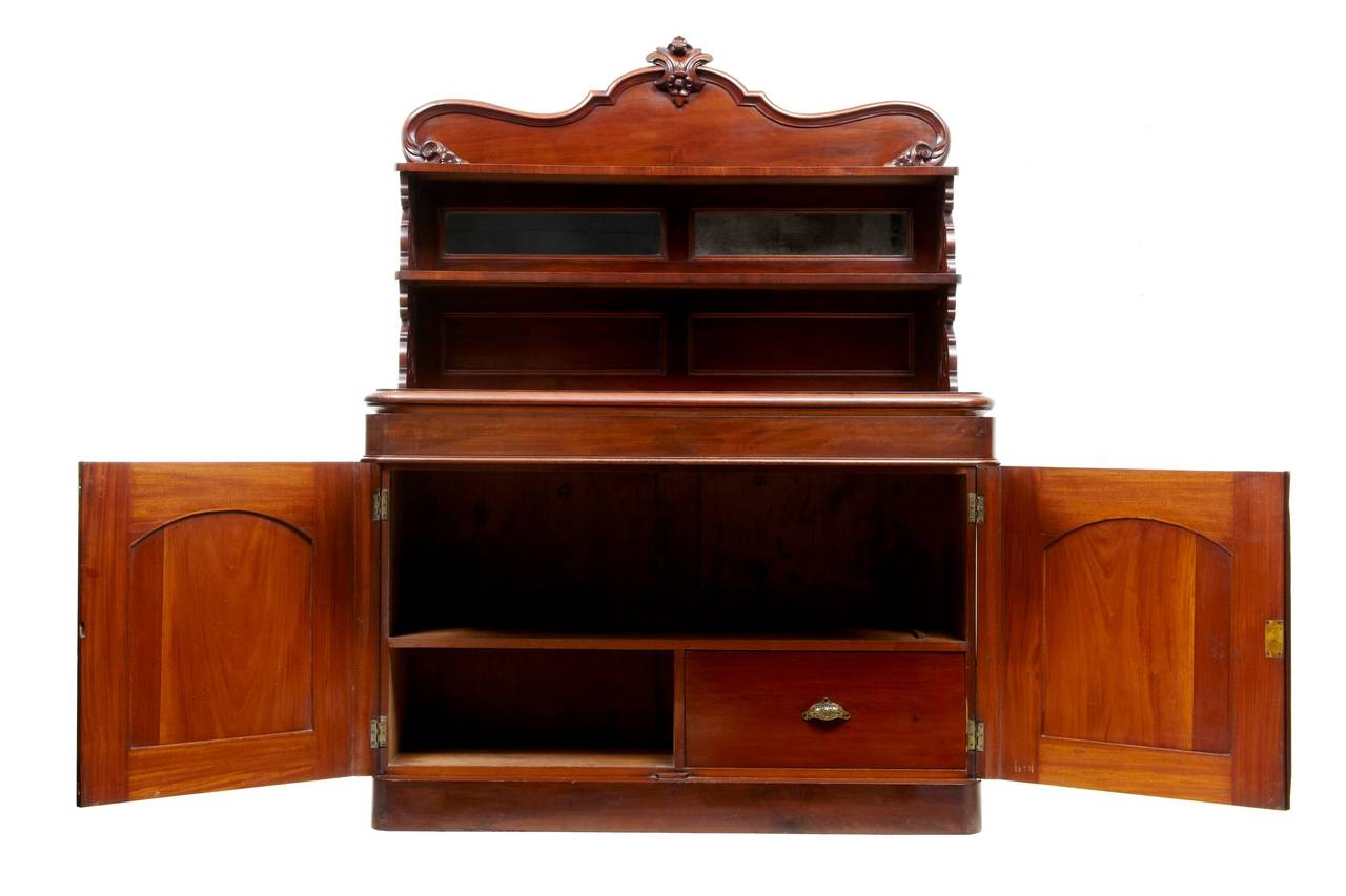 Chiffonnier with Aesthetic Movement influences, circa 1880 

Comprising of 2 sections. The top section with carved ornate gallery and shelf, below which 2 small mirrors above a further shelf leading down the main surface. Pierced fretwork with