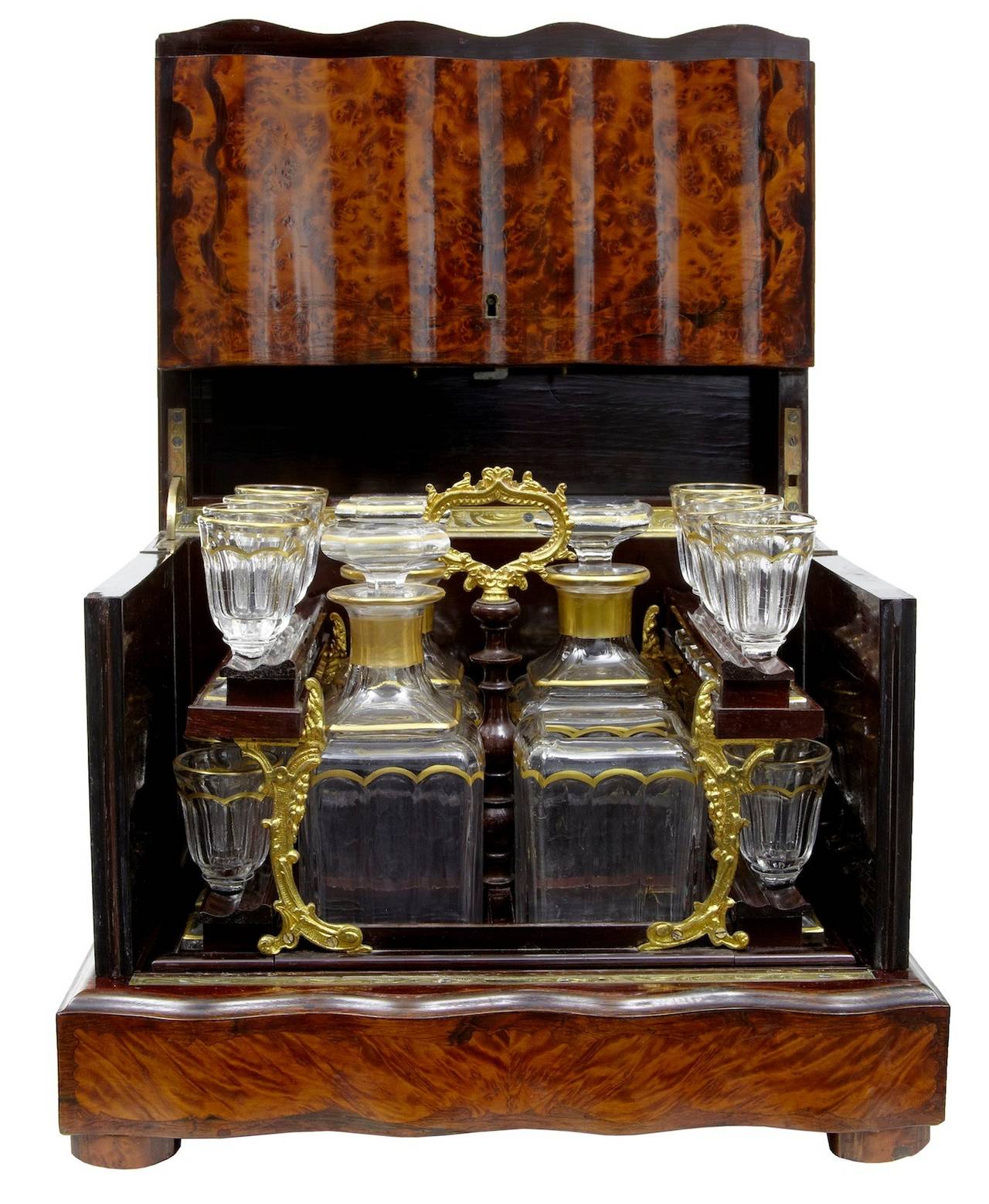 Fine quality french burr tantalus liquer decanter box circa 1890. 

Striking colour and grain which is cross banded on every panel. Front and top hinge and sides swing open to allow access to the ormolu mounted decanter tray. 

16 liquer glasses