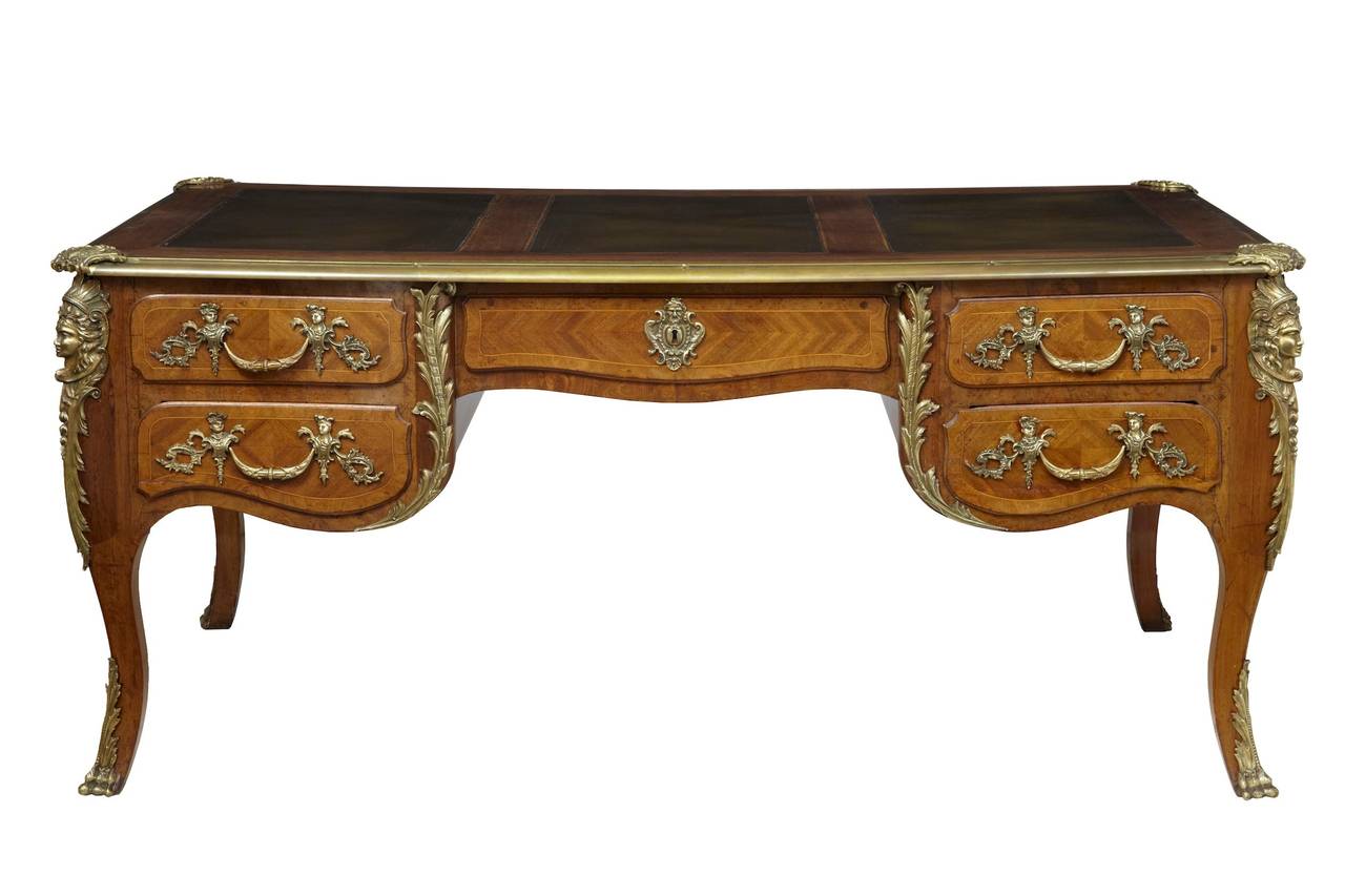 Stunning quality French desk circa 1890. 

Inlaid with various exotic woods and adorned with brass mounts. 

5 drawers to the front which is mirrored by 5 dummies on the reverse of this free standing desk. 

3 brown leather panels on the top