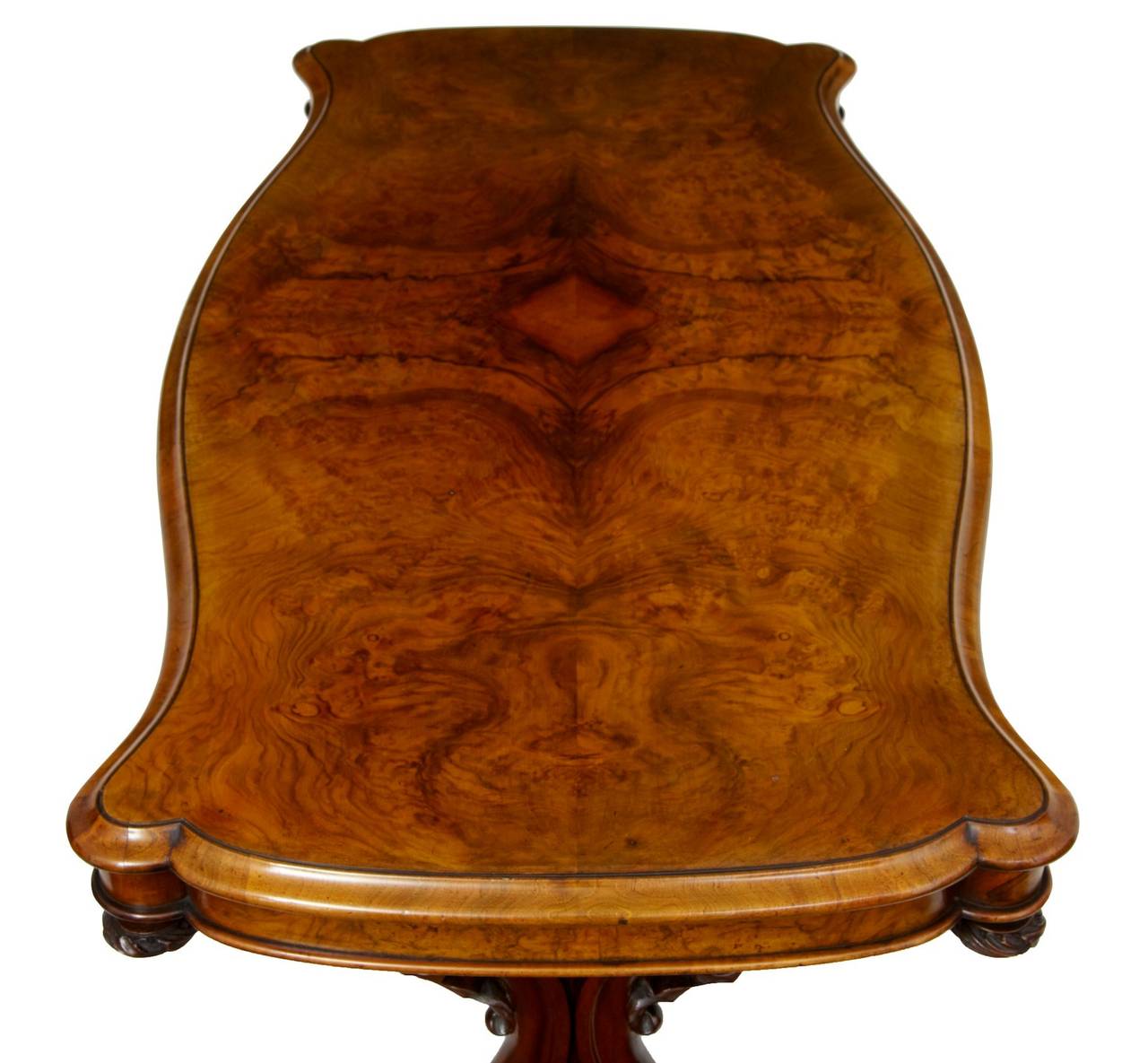 Fine quality serpentine shaped walnut center table circa 1850 

Carved end supports are united by a center stretcher, the crisp carving is the best of victorian craftsmanship.