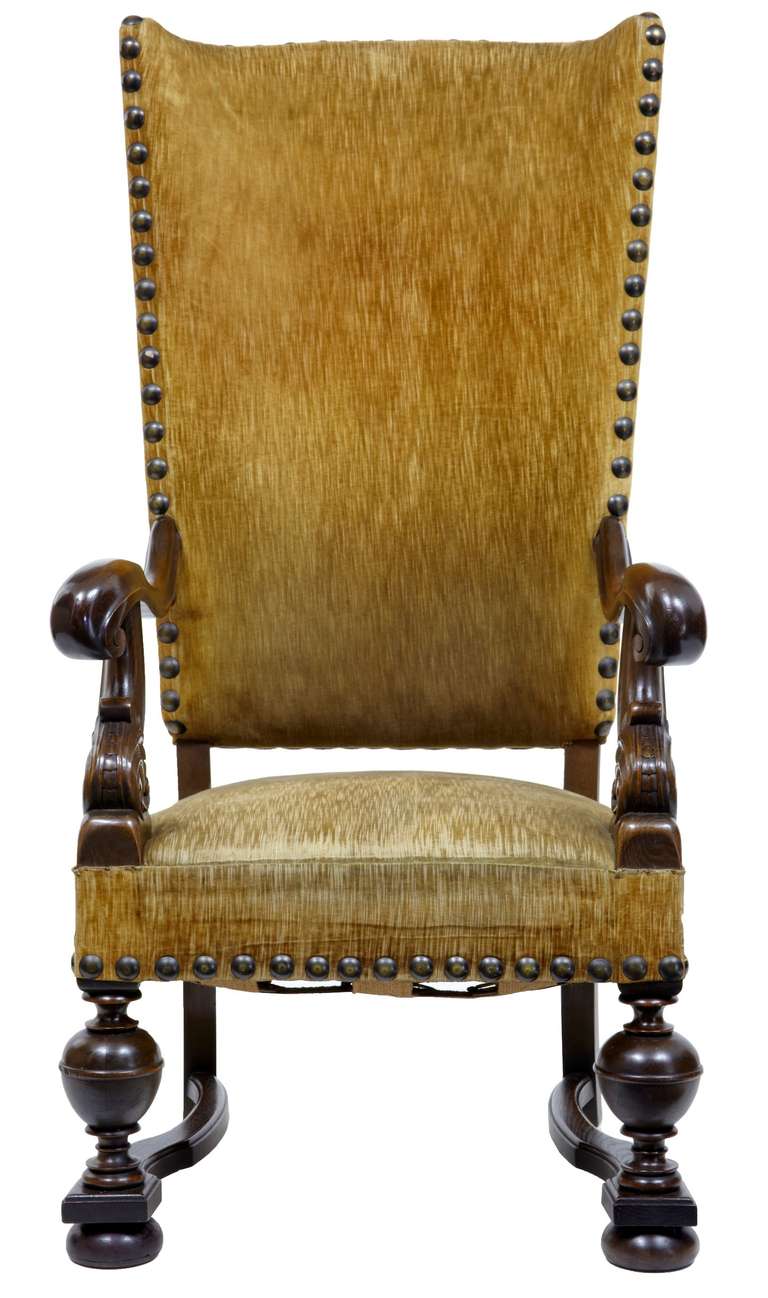 Stunning French oak armchair of large proportions, circa 1880

Featuring carved and scrolled arms, standing on turned legs and bun feet.

Oversized stud work round the edges.

Measures: Height 52 3/4