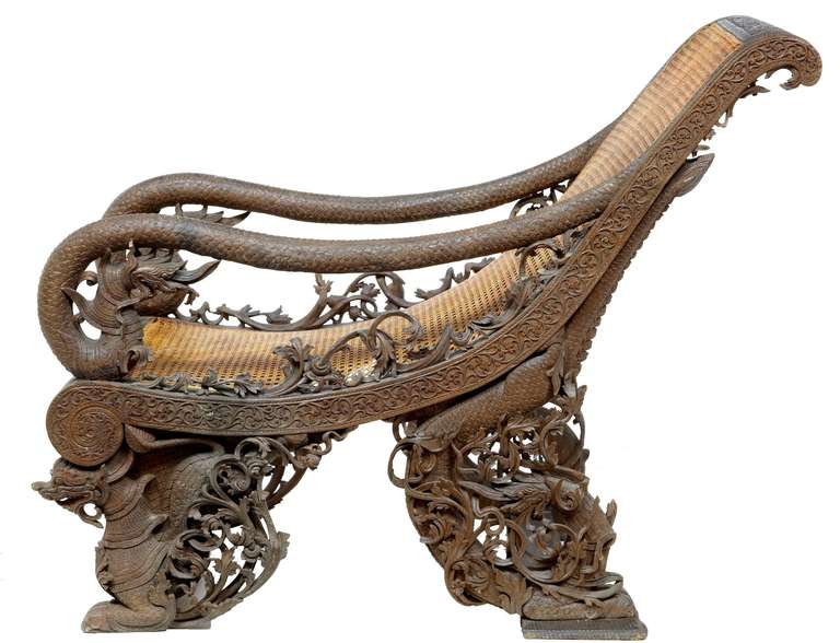 Top Quality Piece Of Handcarved Burmese Craftmanship Circa 1860.

This Carved Teak Chair Depicts Dragons To The Arms And Feet, Profusely Carved With Layered Foliage. Recently Replaced Canework, Minor Losses To Carving.

A Real Collectors Piece.