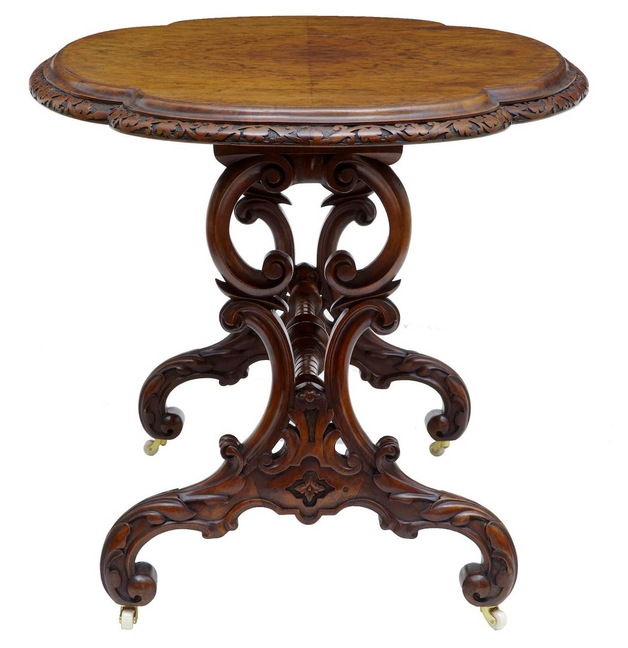 Victorian carved oval occasional table, circa 1860. 

Beautifully carved in the solid around the edge, standing on a pierced and carved base. United by stretcher.

Measures: Height 28 1/2