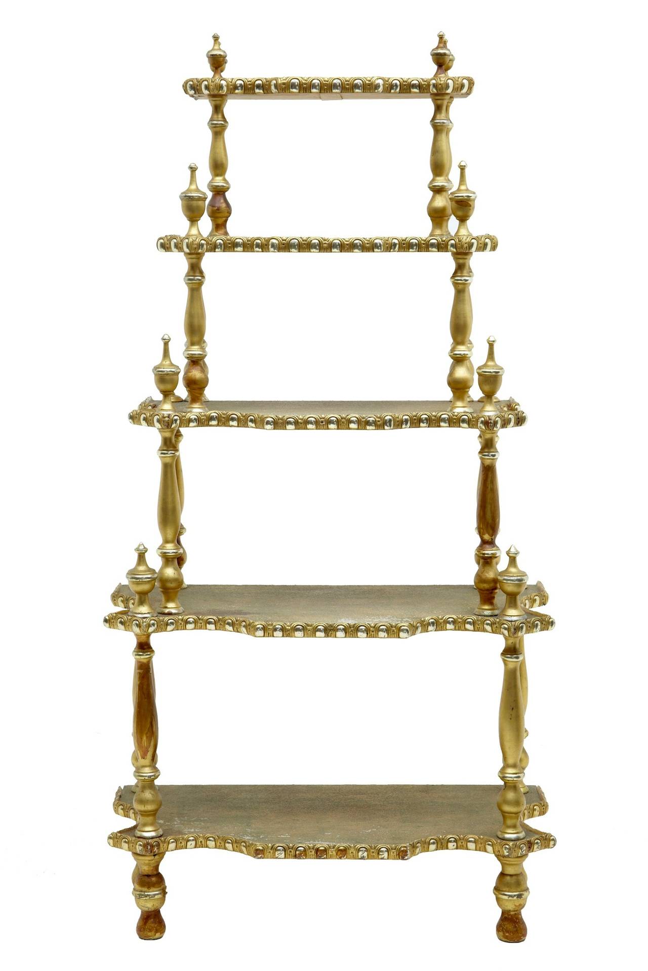 19th century French gilt carved whatnot stand

Unusual whatnot with eastern influences, circa 1890.

Five-tier stand with reverse egg and dart mouldings, united by four turned supports on each section.

Some losses to carving and