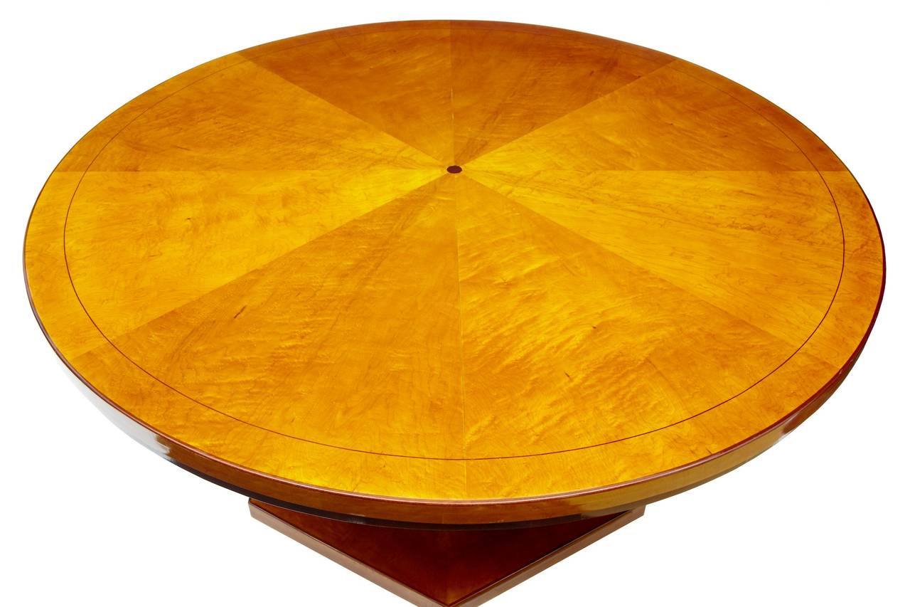 Stunning and substantial art deco round table circa 1920. 

Segmented veneered top with strung outer edge and inner circle, standing on a trumpeted tapering base. 

Rare statement piece.

HEIGHT: 30