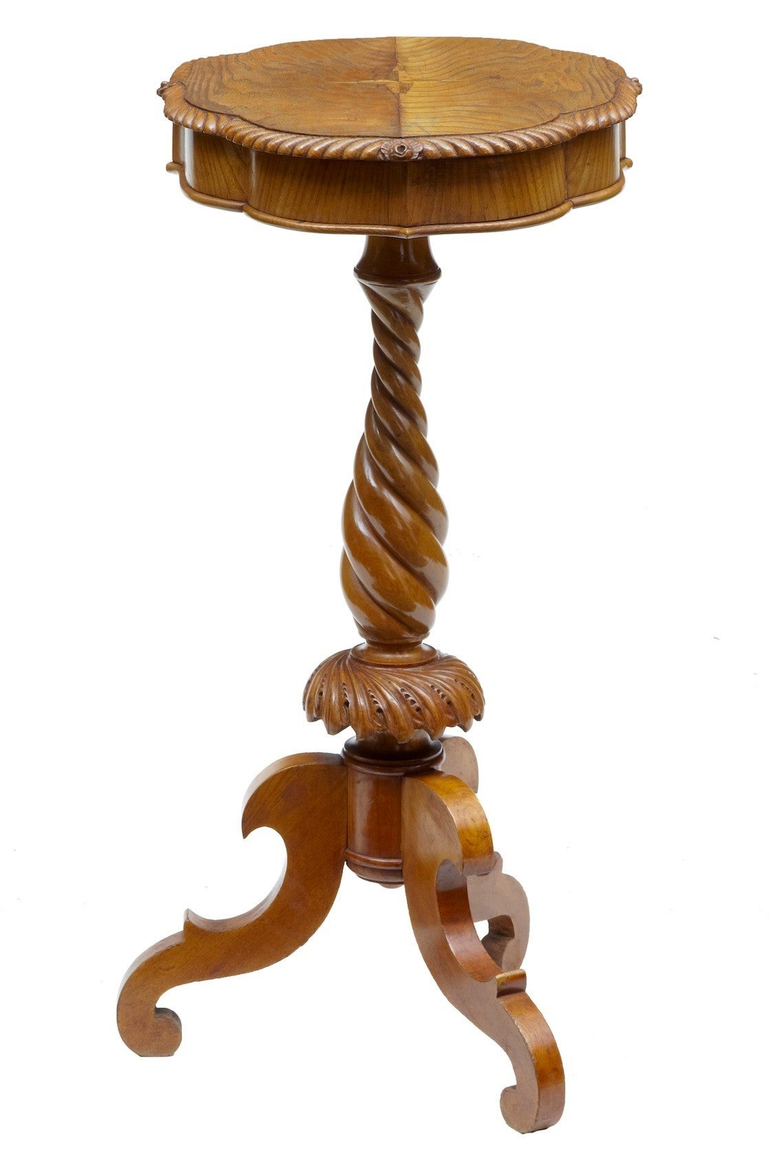 Carved elm occasional table, circa 1890. 

Shaped scalloped edge, standing on turned stem and tripod legs.

Measures: Height: 30 3/4