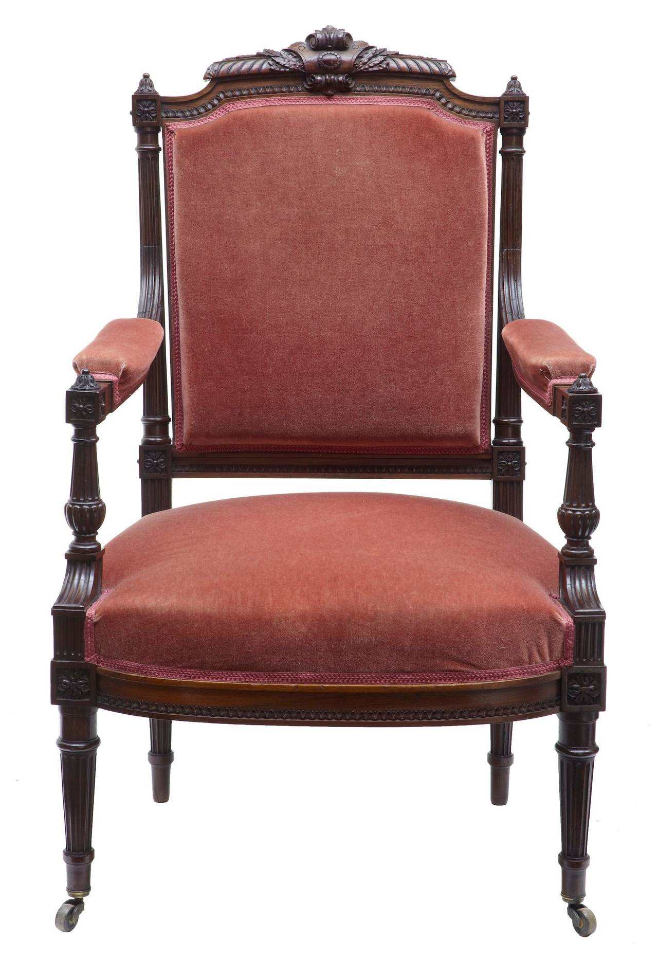 Beautiful carved rosewood armchair, circa 1870. 

Type of chair we can only wish we had a pair of, highest quality carving to the back. 

Fluted arms, back and legs. Standing on brass castors.

Measures: Height: 39 1/2