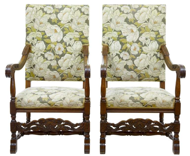 Fine pair of oak armchairs with original needlework fabric, circa 1890.
Original needlework depicts white flowers. Carved element to arm and front rail.

Seat Height: 17 1/4