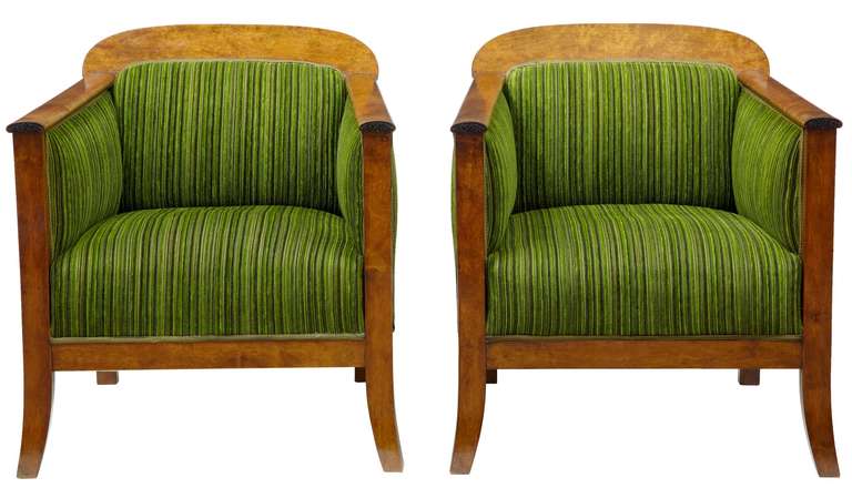 Superb quality pair of swedish mahogany club chairs circa 1870.

In the empire taste, with small carved detail on the arm.

Richly upholstered in green fabric.

Seat height: 16