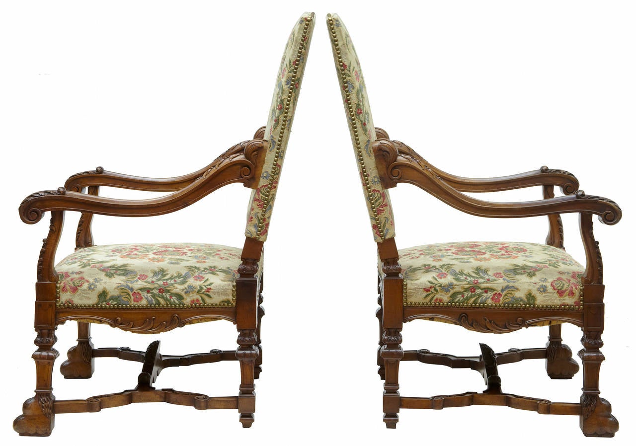 Finest quality pair of large French armchairs, circa 1870. 

Profusely carved with shells, florals and swags 

Shaped arms which terminate in a scroll. 

Carved paw feet united by X-frame stretcher with carved support. 

Original tapestry