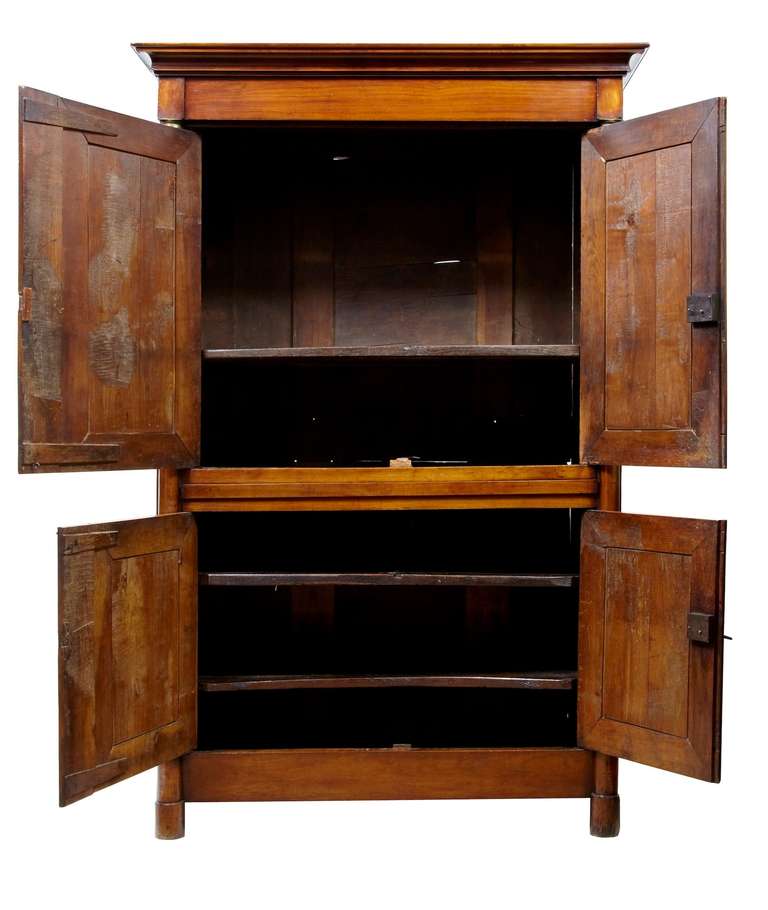 Stunning empire period fruitwood cupboard, circa 1810.

Large in proportions and incorporating typical empire inspired elements, such as the applied brass. Double doors open to reveal original shelves which themselves have great patina.

Working