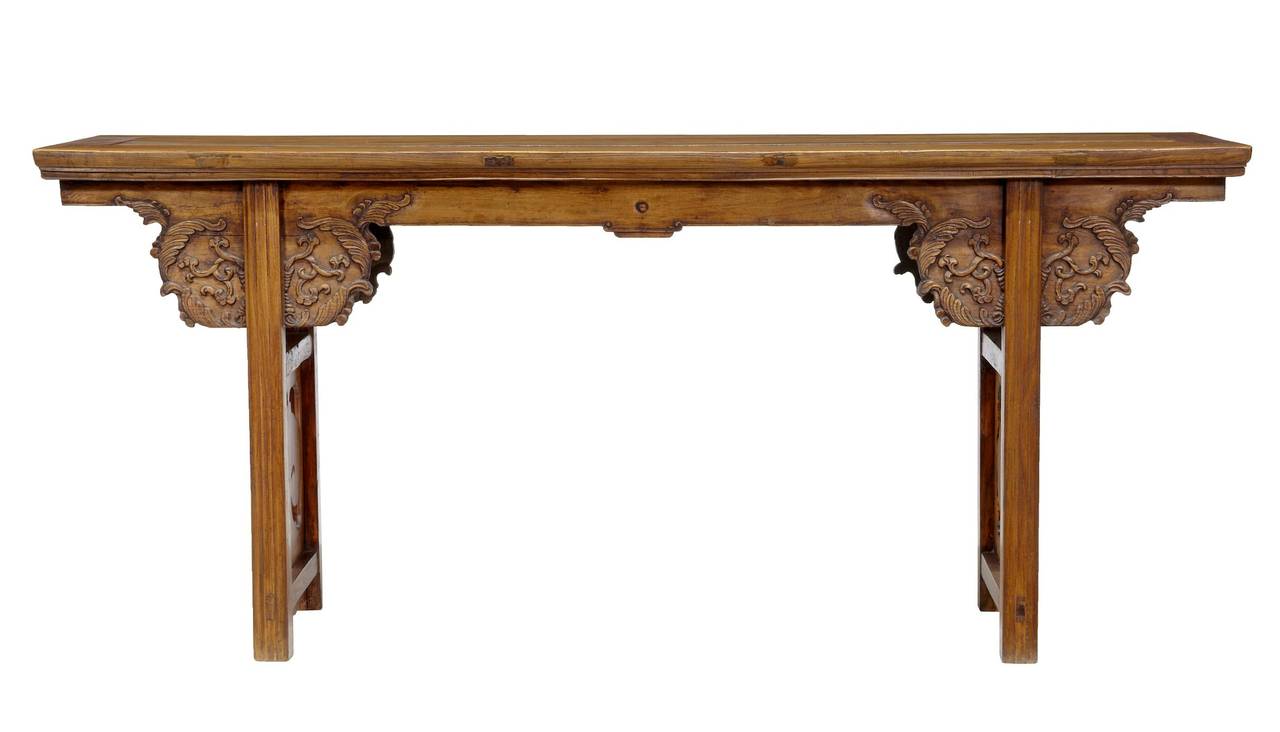 Fine quality carved elm alter table, circa 1860. 
Good color and patina. 
Rectangular top supported by shaped apron, carved foliage with scrolls. Fretwork sides, standing on shaped square legs.

Measures: Height: 33