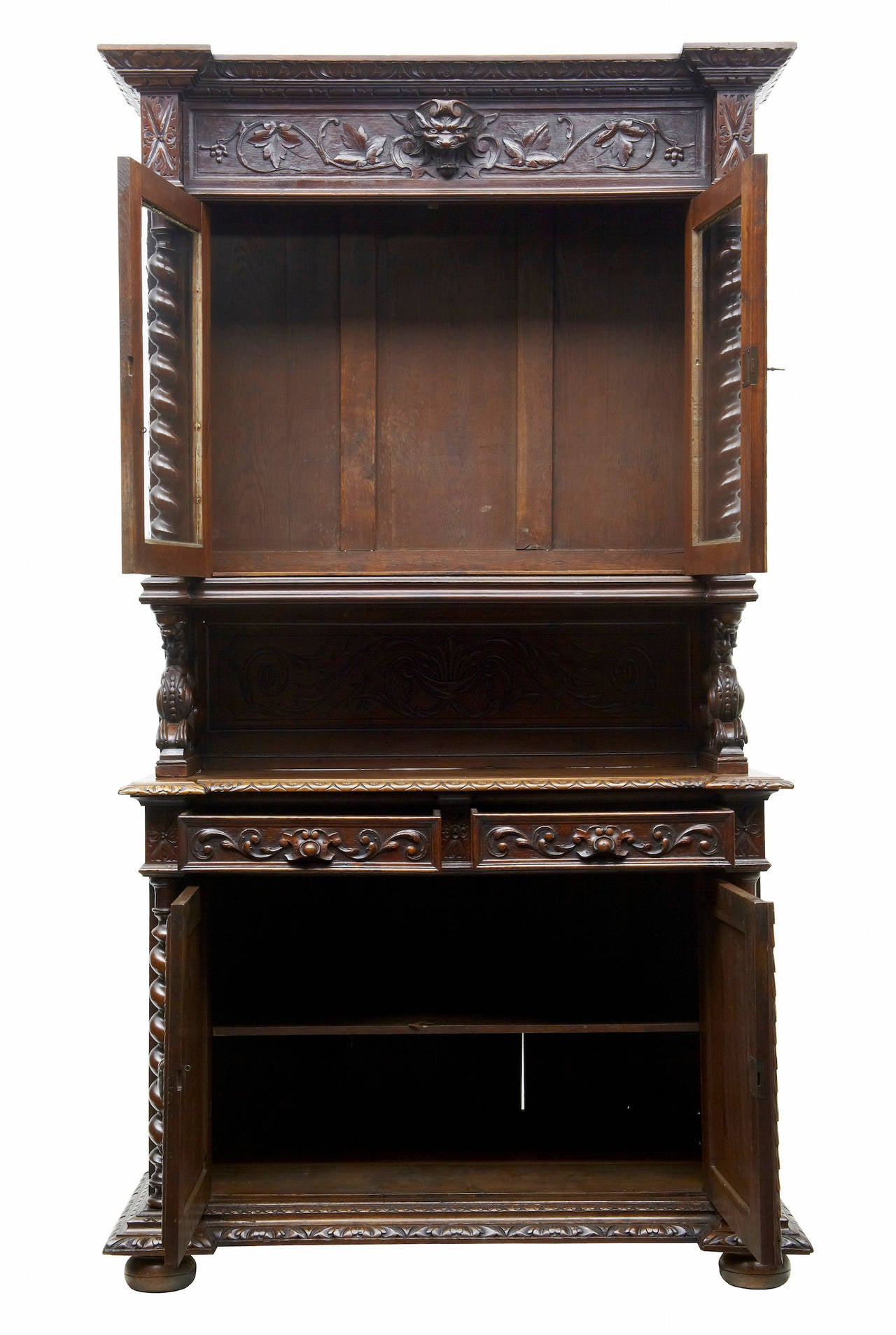 Stunning carved flemish hunt dresser circa 1870. 
Comprising of 3 sections. 
Top section of glazed double door cabinet flanked either side by barley twist columns, surmounted by carved cornice with central grotesque head. This stands on carved