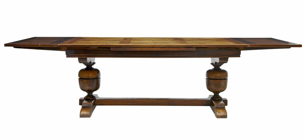 Fine quality French dining table circa 1880. 
Character panelled top with leaves darker in colour due to not being used. 
Standing on baluster supports united by stretcher. 

Width: 70 3/4