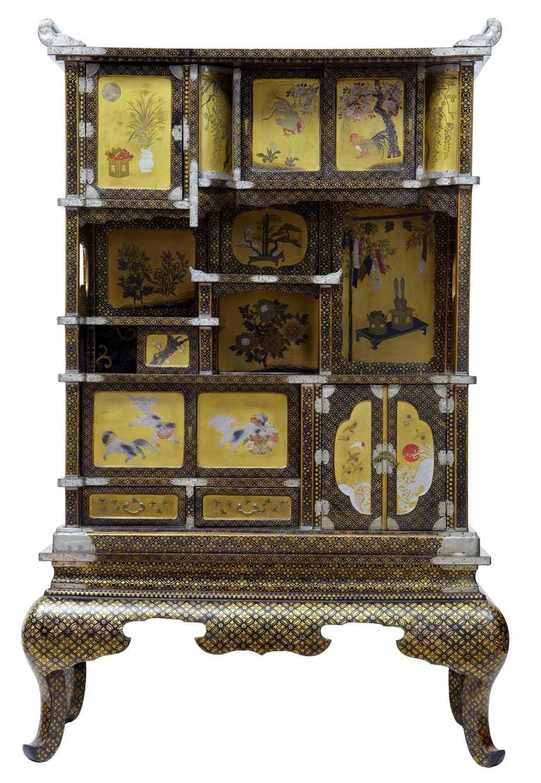 Superb quality Japanese display cabinet, circa 1890.

Contains various scenes from Japanese life on the gold panels, showing birds, dogs, flowers and foliage.

Decorated front and back and on the inside as well.

Splits at the