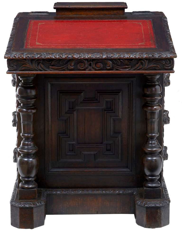 Good Quality Carved Oak Davenport Circa 1880.

Profusely Carved Allover With Foliage And Swags, With A Geometric Design Front And Back. Cherub Heads For Handles To The 3 Drawers On The Side And On The Reverse.

Top Features A Enclosed Well For