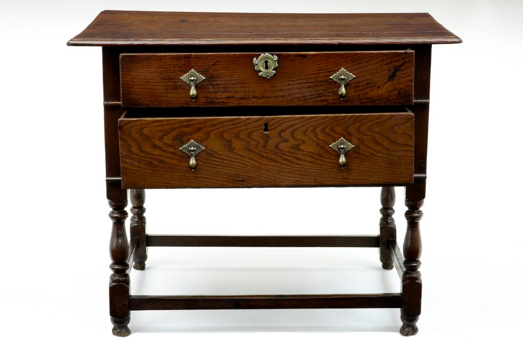 Early 18th century William and Mary oak two-drawer side table
Rare item nice color.
