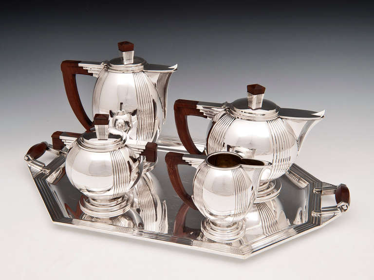 Stunning Art Deco Silver plated Tea Set with exotic Palmwood handles is of the highest quality and has its original silver plated finish. The pieces are stamped RM but so far we have not traced the maker how ever we suspect the piece to be