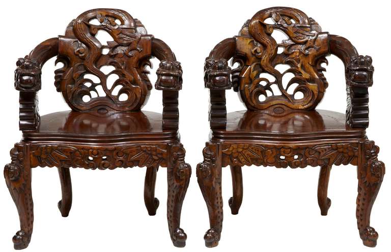 Fine set of four Chinese carved chairs and coffee table, circa 1960.

Substantial and heavy chairs hand-carved with dragons for arms, and a carved pierced recoiled dragon for backs. Carved serpentine coffee table completes the set.

Armchair