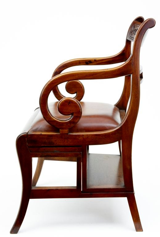 EXCELLENT QUALITY METAMORPHIC MAHOGANY LIBRARY CHAIR WITH LEATHER STEPS AND SEAT.
